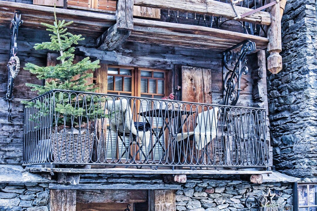 Cozy Swiss chalet interior with wooden beams and stone fireplace