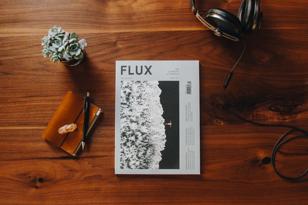Flat lay of a magazine editorial desk with layouts and photographs